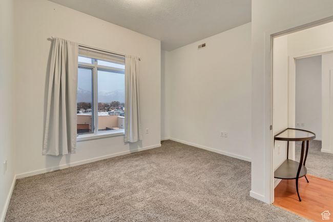 Empty room with baseboards, carpet, and a textured ceiling | Image 22