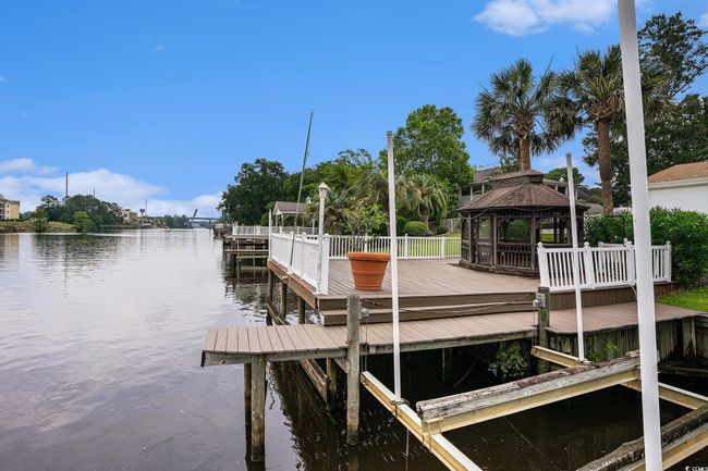 Dock area featuring a gazebo and a water view | Image 37