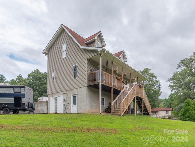 Another view of the home from the lot/ Exterior extrance to the basement space, as well as inside entrance | Image 25