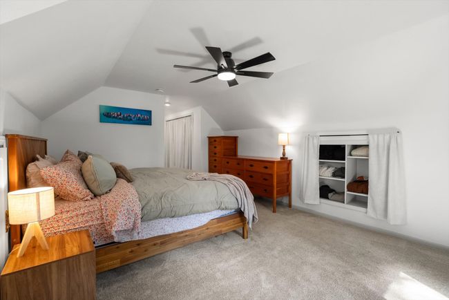 Carpeted bedroom with lofted ceiling, a closet, and ceiling fan | Image 31