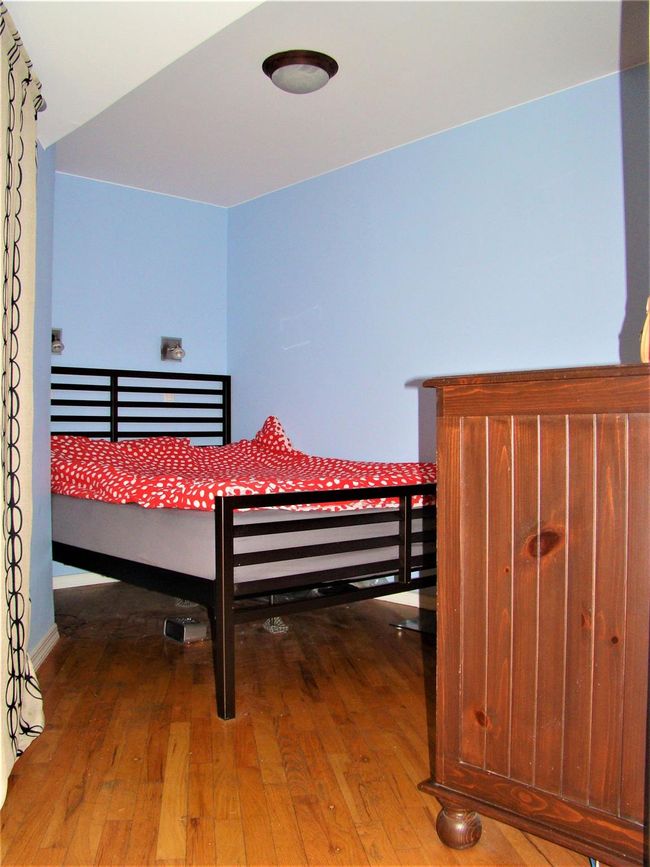 Bedroom featuring wood-type flooring | Image 6