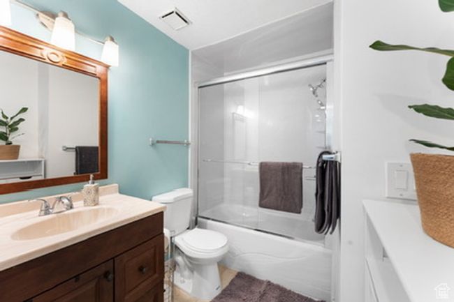 Bathroom with vanity, bath / shower combo with glass door, and tile patterned flooring | Image 6