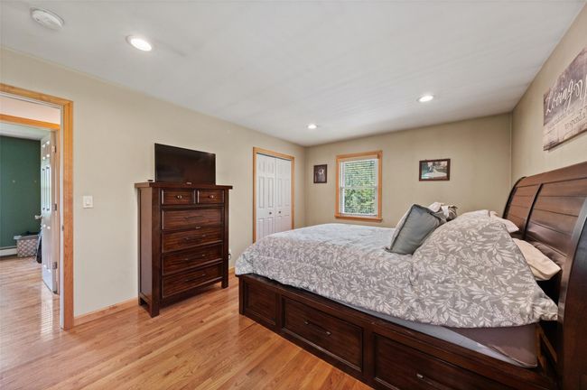 Bedroom featuring recessed lighting, light wood-style flooring, a closet, baseboard heating, and baseboards | Image 19