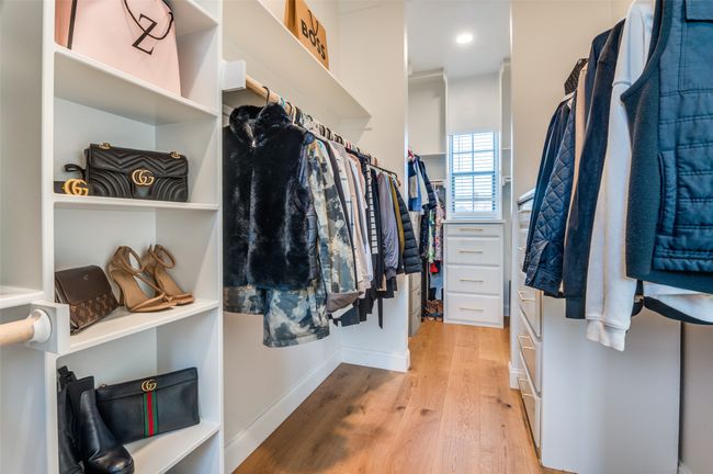 Spacious closet with light wood-style flooring | Image 25