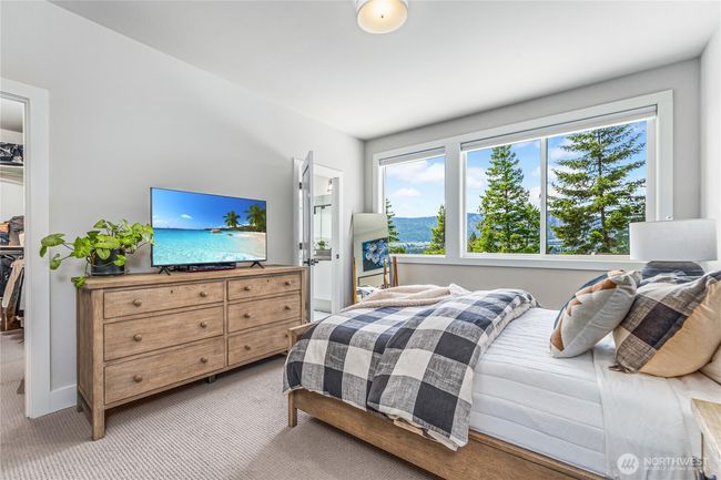 Wake up to breathtaking mountain views in the spacious primary bedroom, a serene retreat featuring oversized windows, a luxurious atmosphere, and a huge walk-in closet | Image 16