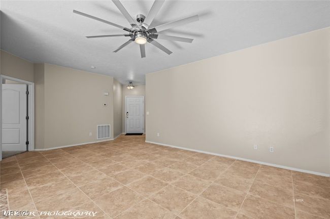 Unfurnished room featuring baseboards, visible vents, light tile patterned floors, and a ceiling fan | Image 6