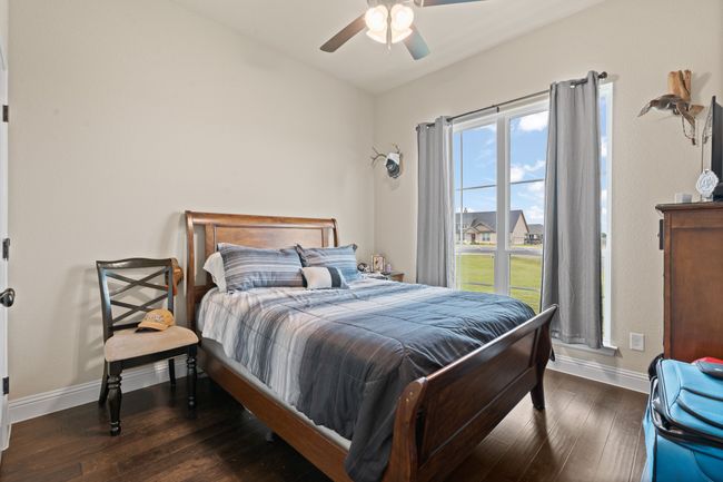 Bedroom featuring wood-type flooring and ceiling fan | Image 21