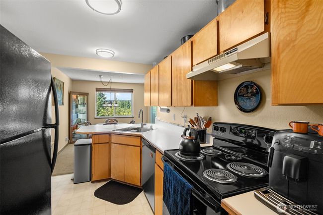 Well designed kitchen with a newer stove | Image 10