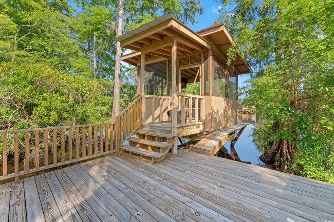 Wooden deck featuring a sunroom and stairway | Image 31