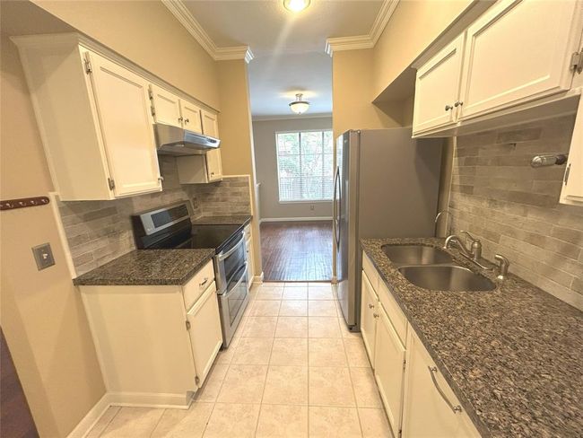 Rounding out the kitchen updates are a granite countertop, stone-look backsplash and a reverse osmosis system filtered water system under the kitchen sink with a separate faucet for drinking water. | Image 22