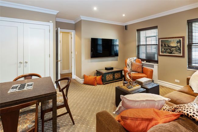 Living room with radiator, ornamental molding, light carpet, and recessed lighting | Image 10