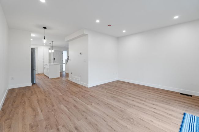Unfurnished living room with recessed lighting, visible vents, baseboards, and light wood-style floors | Image 22
