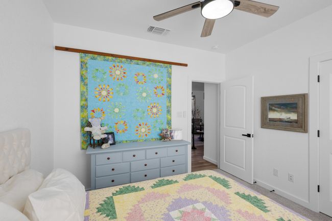 Bedroom with visible vents and a ceiling fan | Image 17
