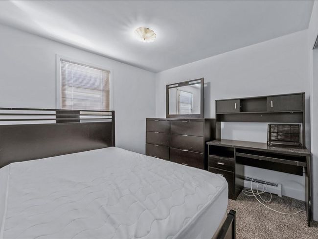 Carpeted bedroom with a baseboard radiator | Image 20