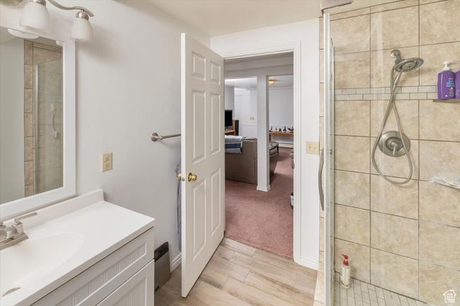 Bathroom with vanity and tiled shower | Image 36