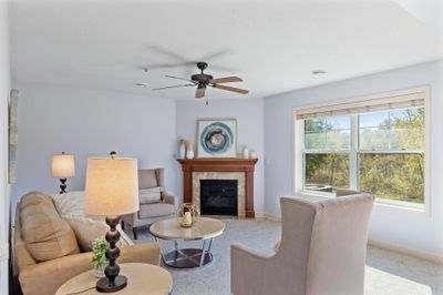 Living Room with gas fireplace and a wall of windows | Image 1