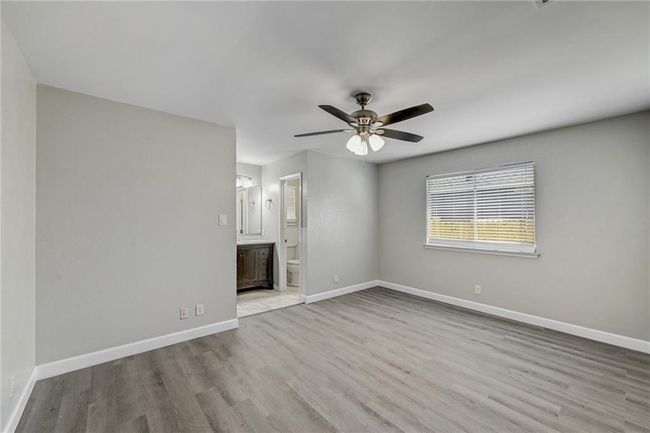 Spare room with wood finished floors, baseboards, and ceiling fan | Image 22
