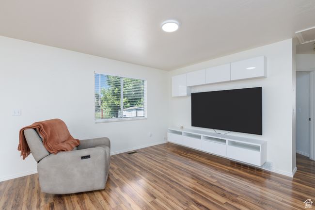 Living area featuring wood finished floors and baseboards | Image 9