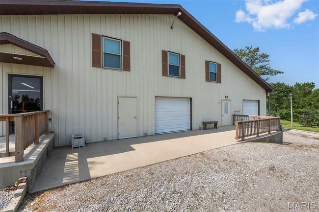 Rear view of house with driveway and a garage | Image 60