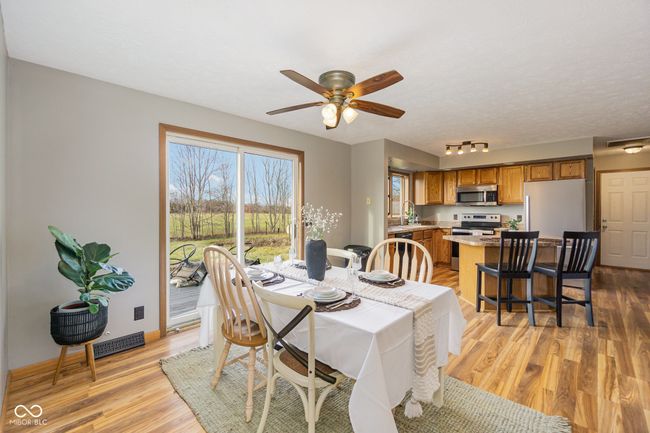 dining space featuring baseboards, visible vents, light wood-style flooring, and ceiling fan | Image 8
