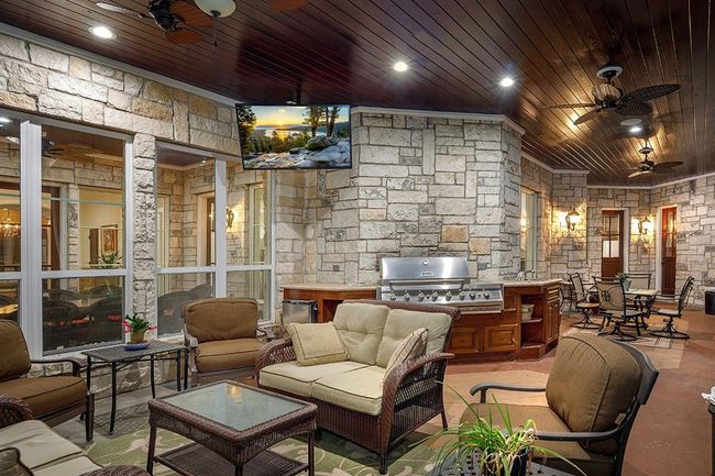 The outdoor kitchen in the screened in patio is ideal for entertaining | Image 45