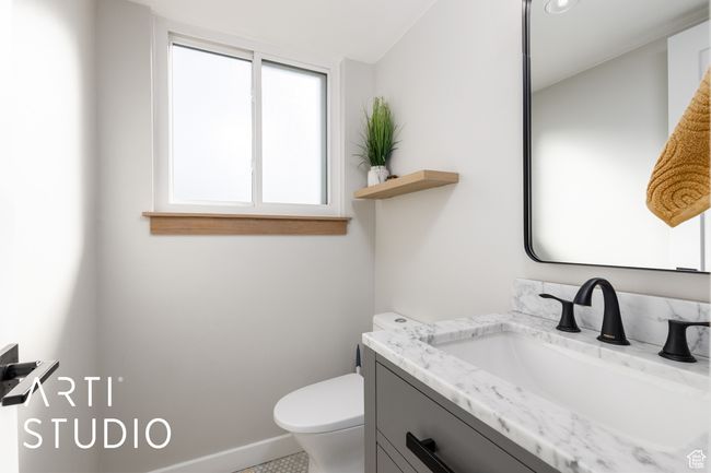Half bath featuring baseboards, toilet, and vanity | Image 17