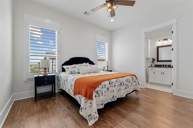 Bedroom with a sink, baseboards, and wood finished floors | Image 6