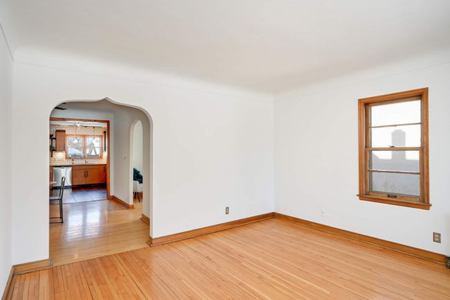 The living room flows easily into the dining room and beyond. | Image 7
