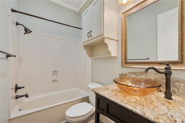 Bathroom with ornamental molding, toilet, washtub / shower combination, and vanity | Image 12