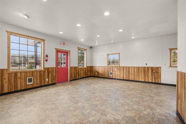 Empty room featuring a wainscoted wall, wood walls, recessed lighting, stone finish floors | Image 56