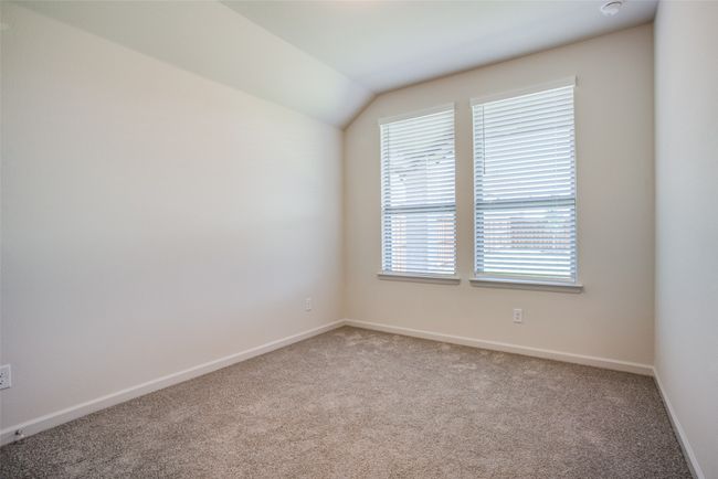 Unfurnished room with carpet floors, baseboards, and vaulted ceiling | Image 13