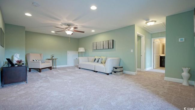 Living room with attic access, light colored carpet, a ceiling fan, baseboards, and recessed lighting | Image 29