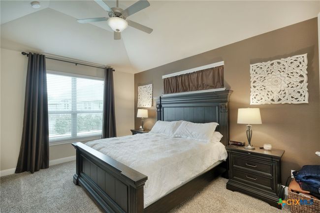 Primary bedroom is spacious with ceiling fan, lots of natural lighting. | Image 13