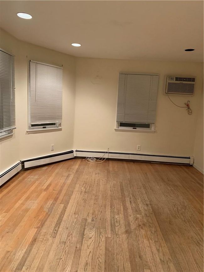 1sr Fl Unfurnished room featuring light wood-type flooring and a wall mounted air conditioner | Image 14