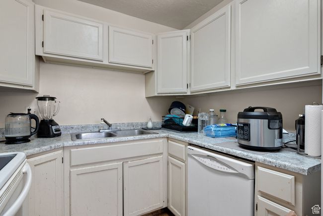 Kitchen with dishwasher, light countertops, and white cabinets | Image 50