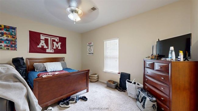 Carpeted bedroom featuring visible vents, ceiling fan, and baseboards | Image 15