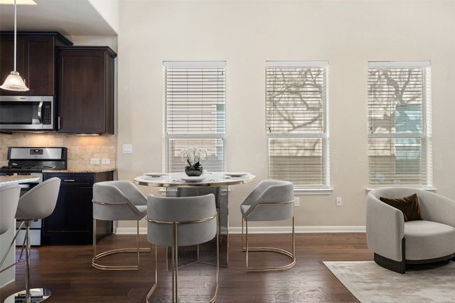 Virtually Staged: The spacious dining area seamlessly connects the kitchen and living room. | Image 8