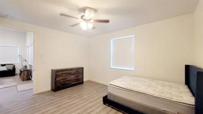 Bedroom featuring wood finished floors and ceiling fan | Image 14