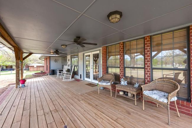 Wooden terrace with french doors and a ceiling fan | Image 28
