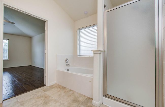 Primary bath has a garden soaking tub and separate shower. | Image 23