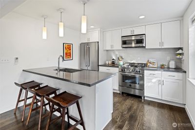 Kitchen has gas range, stainless steel appliances and ample space to sit and counterspace. | Image 3