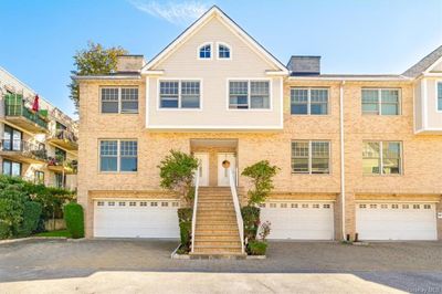 Townhome / multi-family property featuring a garage | Image 1