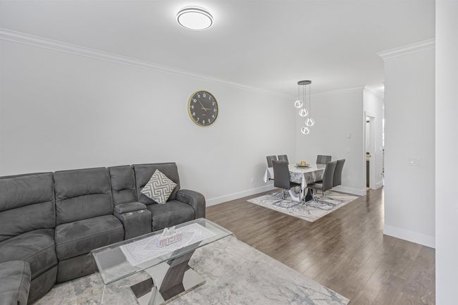 Living area with ornamental molding and wood finished floors | Image 4