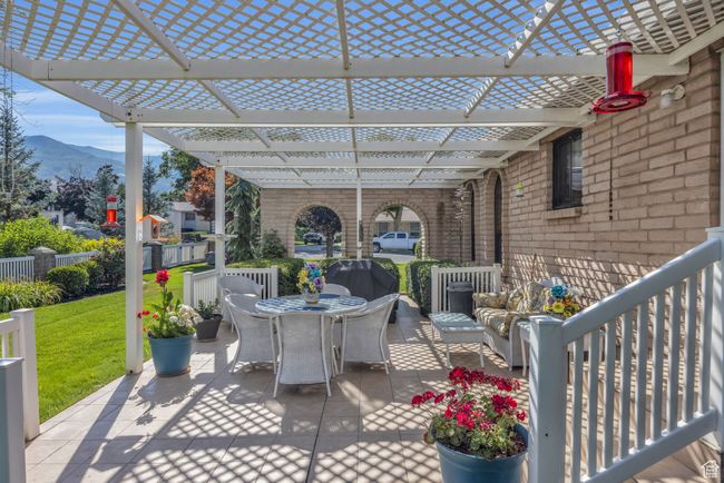 View of patio featuring outdoor dining area, a pergola, and a mountain view. Built in bbq | Image 32