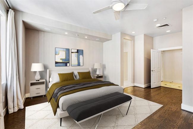 Primary suite with neutral window treatments. | Image 19