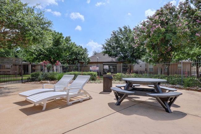 Several tables and lounge chairs surround the pool. | Image 34