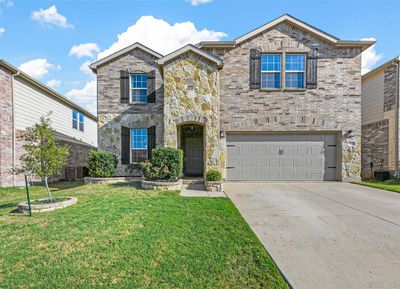 View of front property with a garage, cooling unit, and a front lawn | Image 1