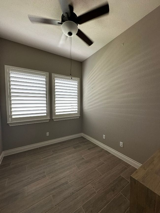 Spare room featuring ceiling fan and dark wood-type flooring | Image 20