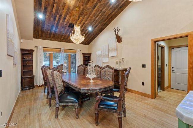 Dining space with baseboards, high vaulted ceiling, wooden ceiling, and light wood-style floors | Image 31