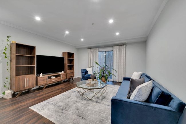 Living room with recessed lighting, dark wood-style floors, and crown molding | Image 9